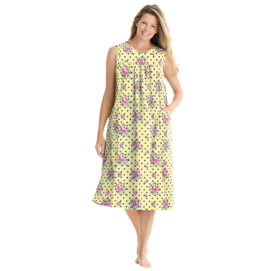 Plus-size woman wearing a sleeveless, mid-length lounger with a banana dot floral print, scoop neckline, shirred yoke, and side pockets.