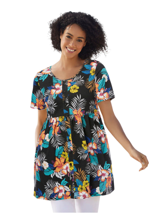 Plus size woman wearing black tunic with colorful hibiscus tropical print and empire waist