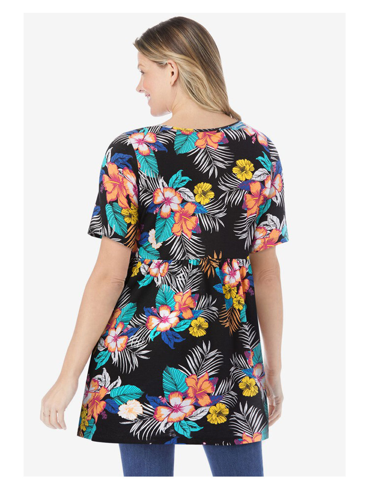 Plus size woman wearing black tunic with colorful hibiscus tropical print and empire waist