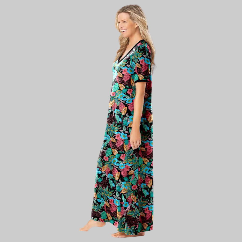 Plus-size woman wearing a black floral maxi T-shirt lounger with short sleeves, V-neckline, and side pockets on a white background.