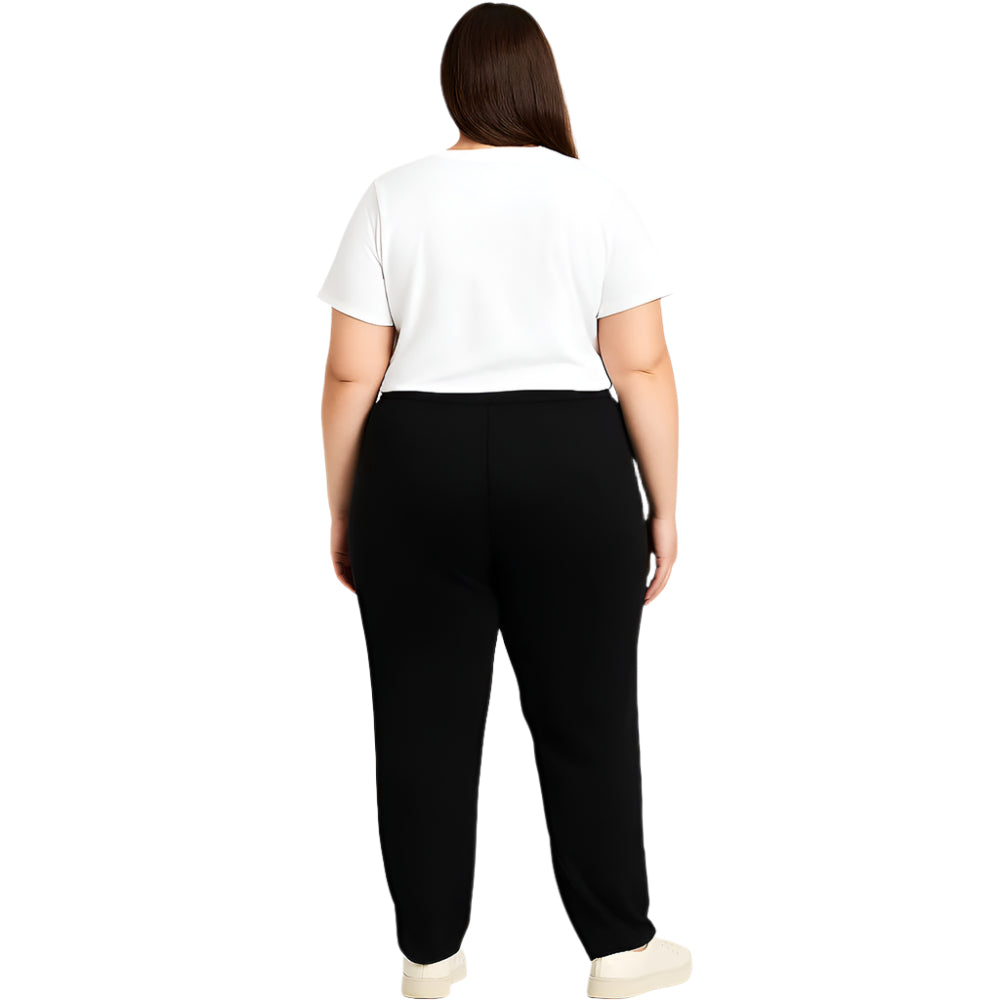 Plus size woman wearing high-rise black performance activewear leggings in studio