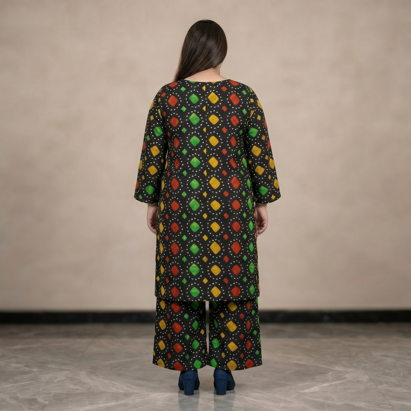 Woman wearing a colorful patterned outfit with a neutral background