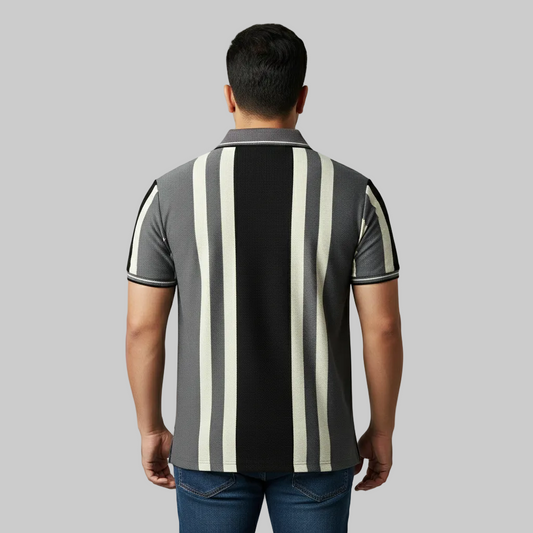 Charcoal grey and black vertical stripe polo t-shirt worn by a male model, featuring a classic collar and short sleeves on a studio background