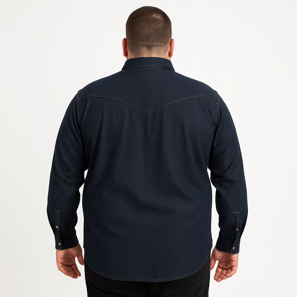 Plus-size male model wearing a dark indigo denim western shirt with chest pockets, button-down front, and long sleeves, studio shot on a clean white background.