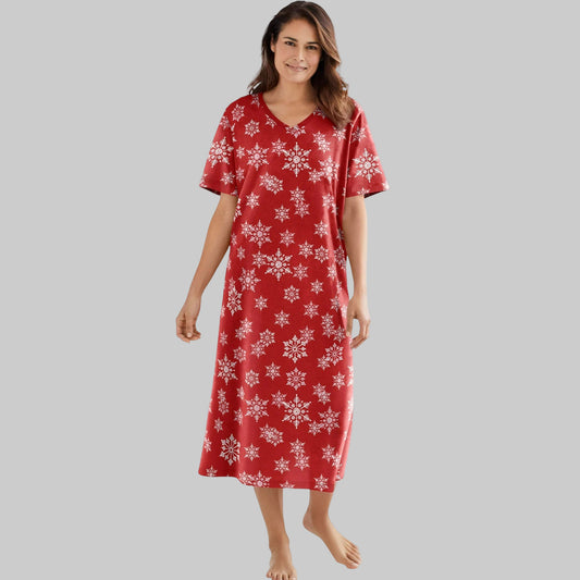 Woman wearing red sleepshirt with white snowflake print and V-neck design