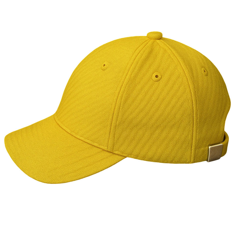 Classic yellow baseball cap with zebra-textured fabric and silver buckle on wooden surface.