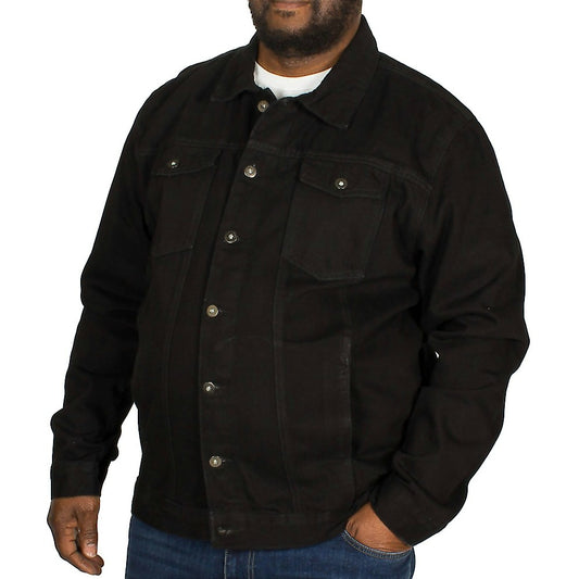 Plus-size male model wearing a classic black denim jacket with button-down front, straight collar, and chest flap pockets, photographed in a studio on a white background