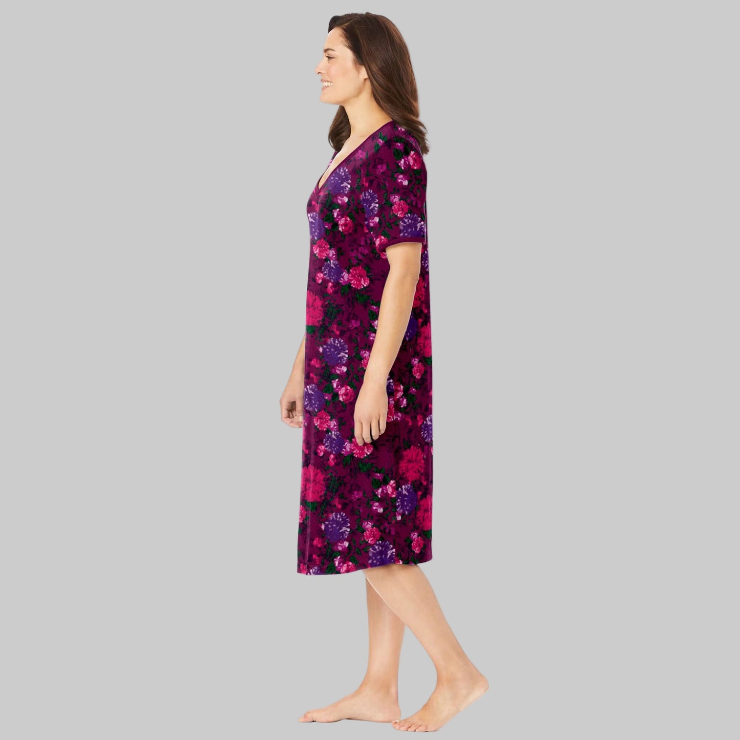 Plus-size woman wearing a deep claret floral short T-shirt lounger with V-neck, short sleeves, and side pockets, on a white background.