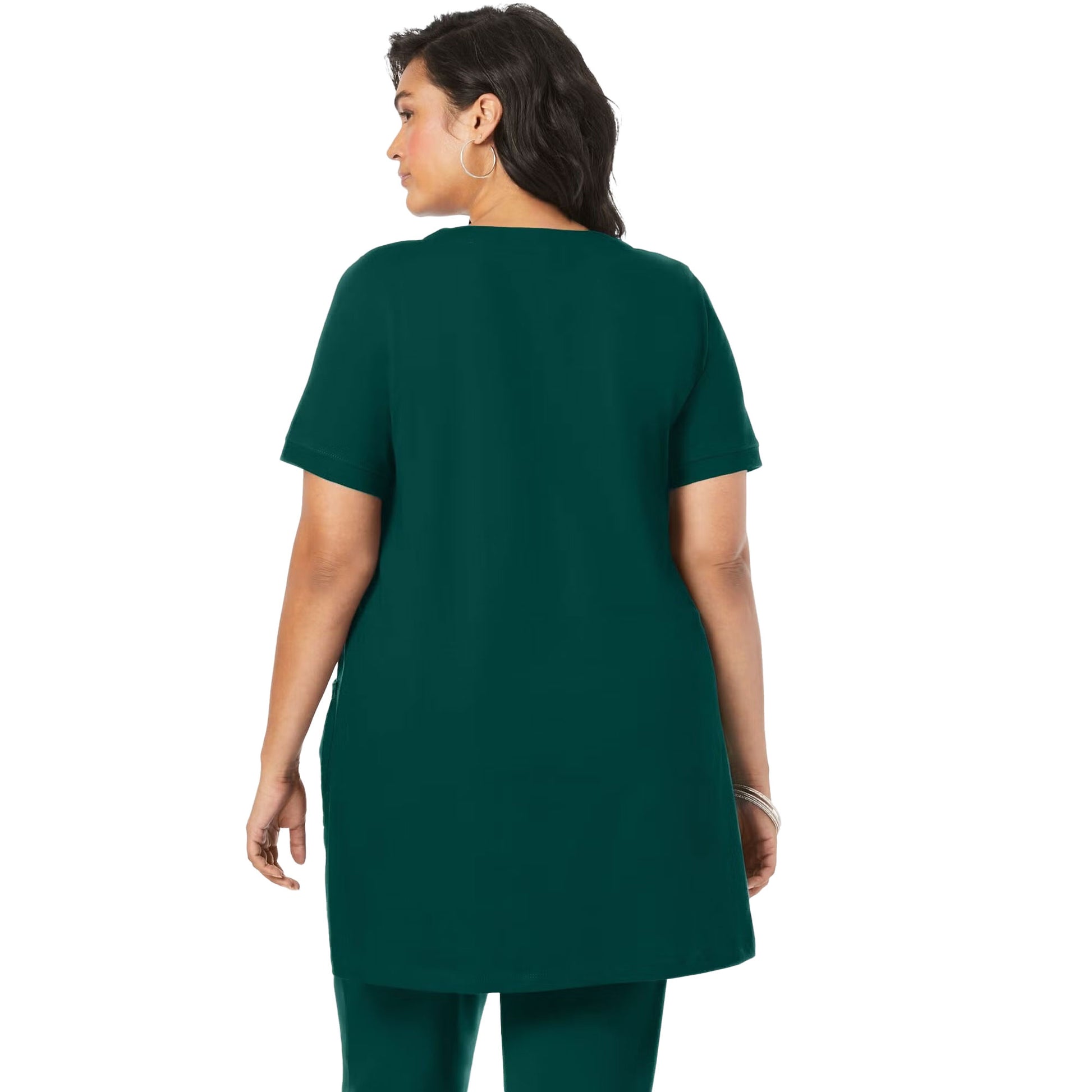 Emerald green knit women’s tunic with two front pockets, draped on a hanger with a white background