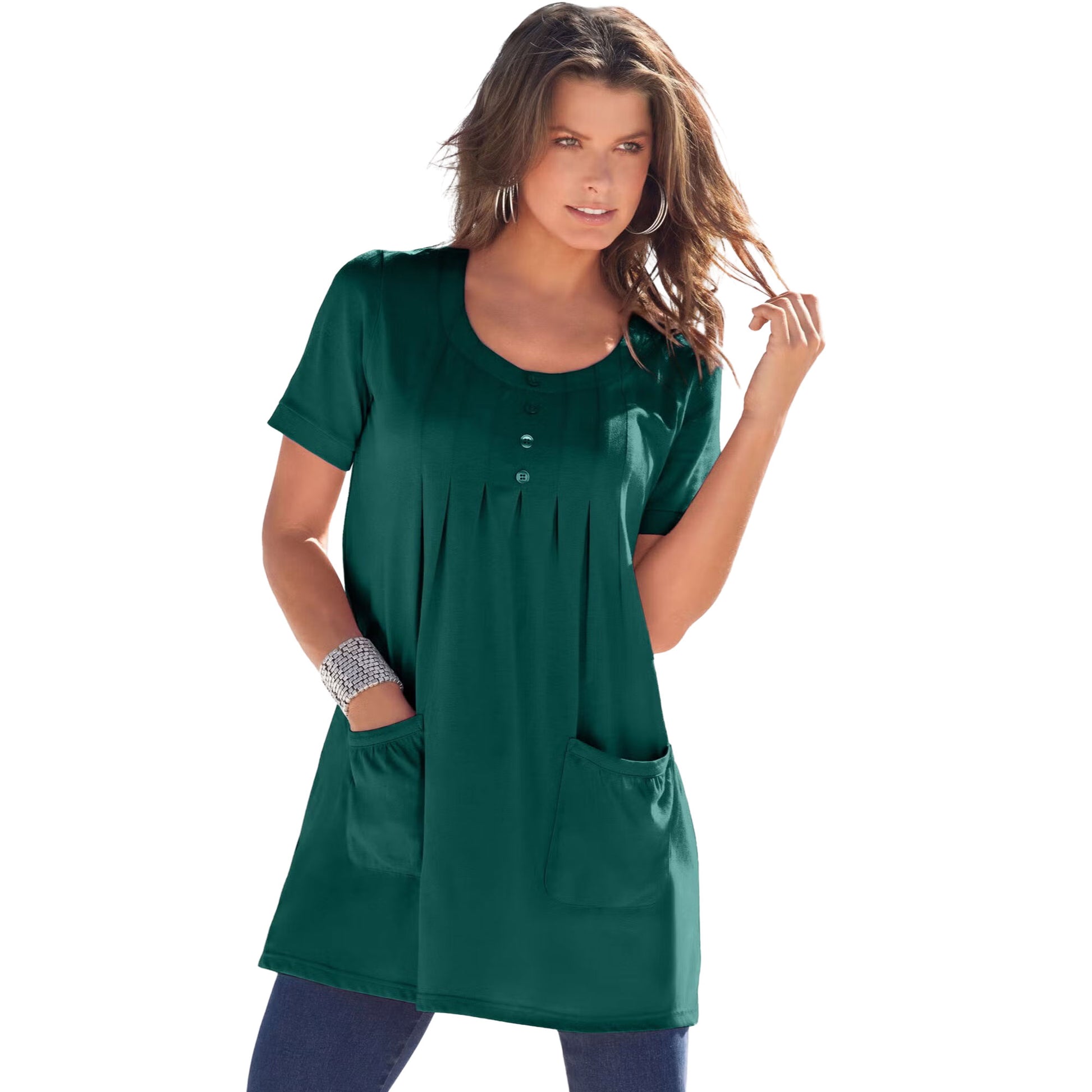 Emerald green knit women’s tunic with two front pockets, draped on a hanger with a white background
