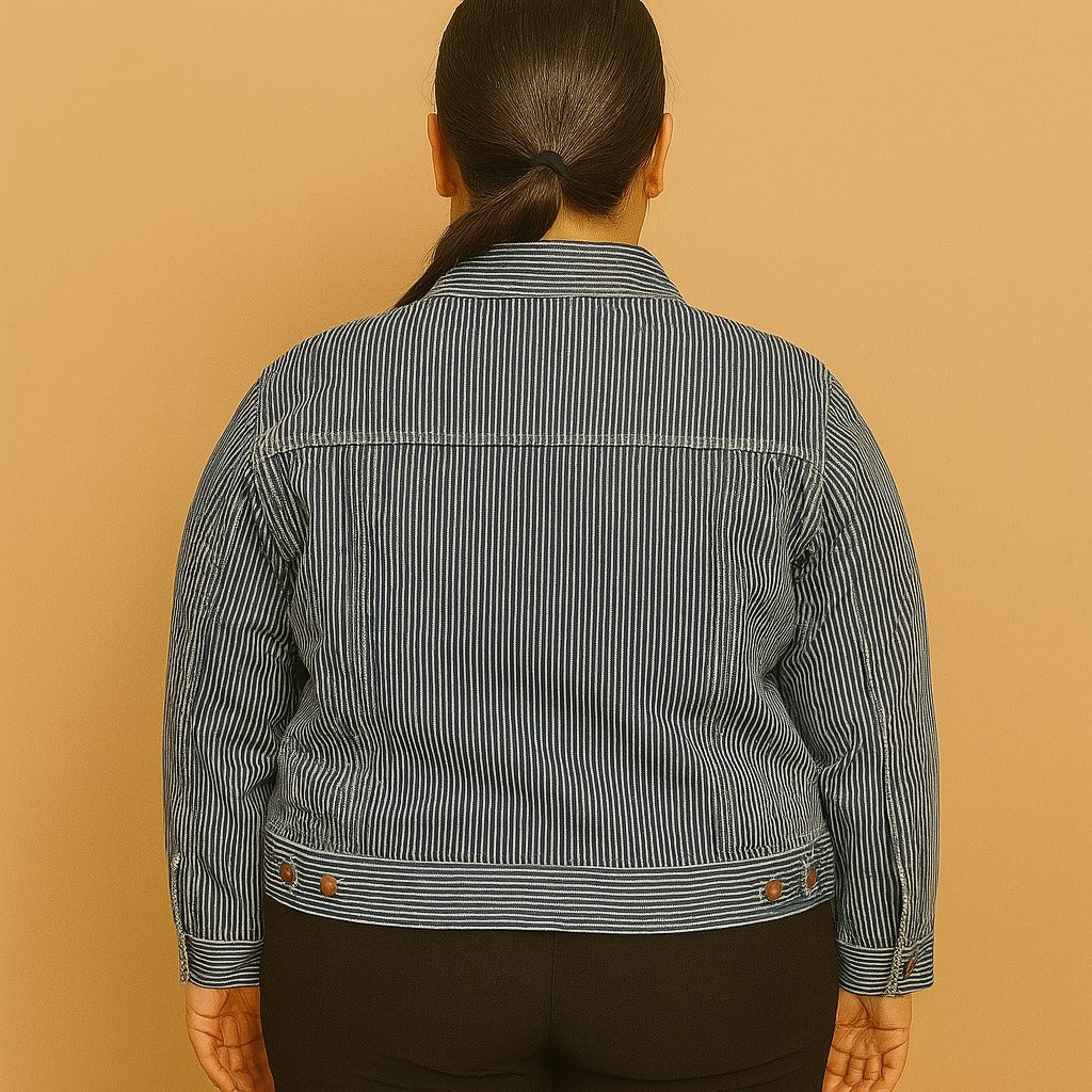 Plus-size woman wearing a vintage blue striped jean jacket with chest pockets and button closure