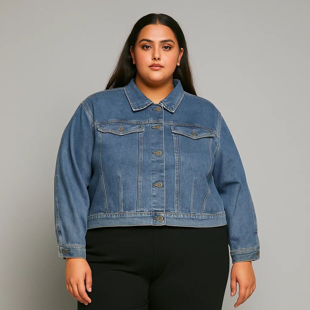 Plus-size woman wearing a soft indigo denim jacket with chest pockets and button-down front