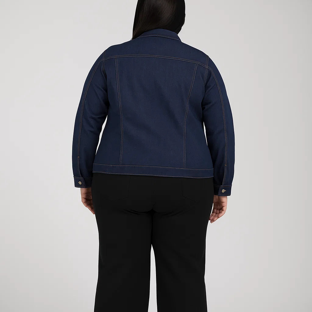 Plus-size woman wearing a dark indigo denim jacket with contrast stitching and flap pockets