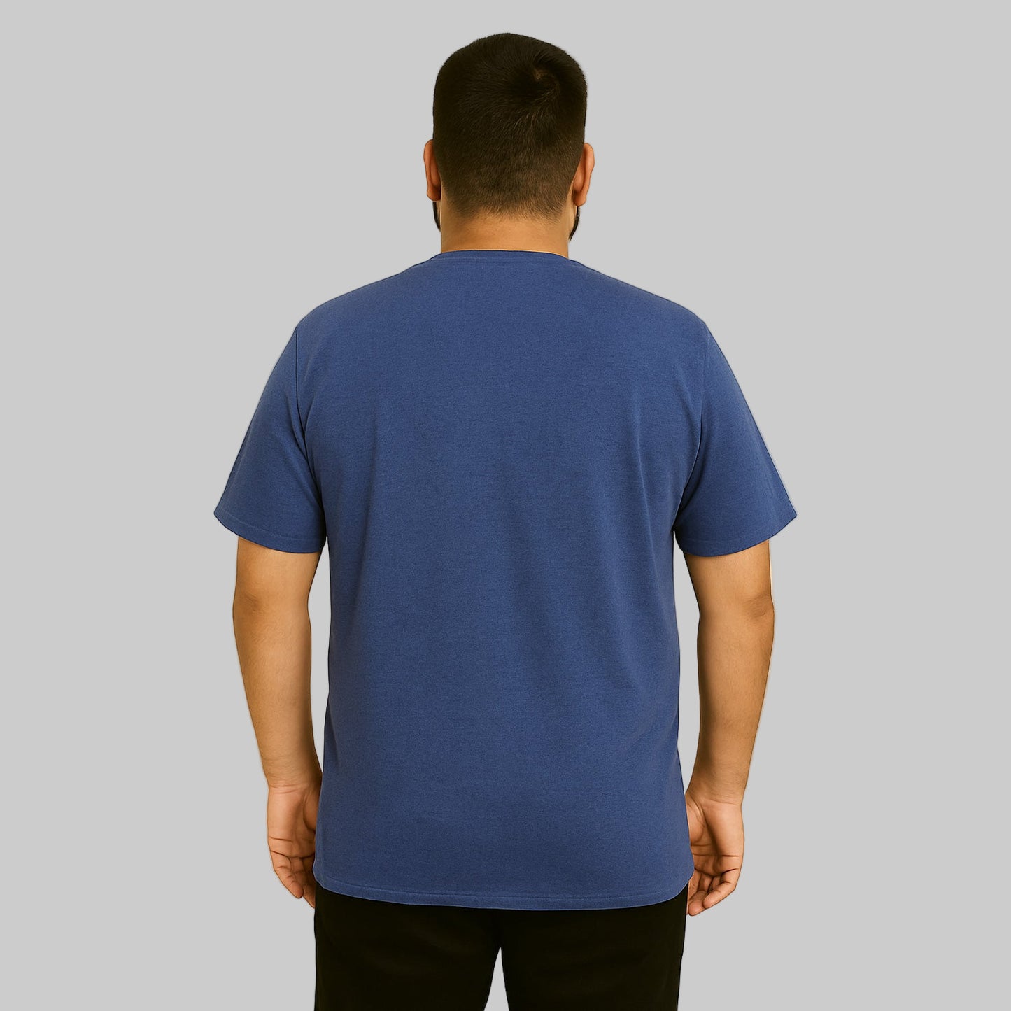 Plus-size Pakistani male model wearing heather navy crewneck T-shirt with chest pocket on a light studio background.
