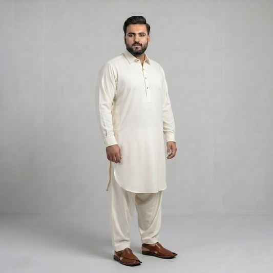 Man wearing a white kurta with brown shoes on a gray background