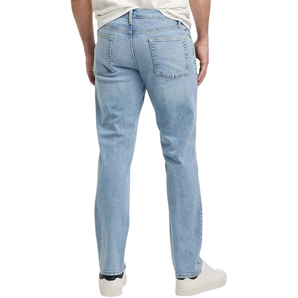 Light blue men's athletic fit jeans with button fly on white background