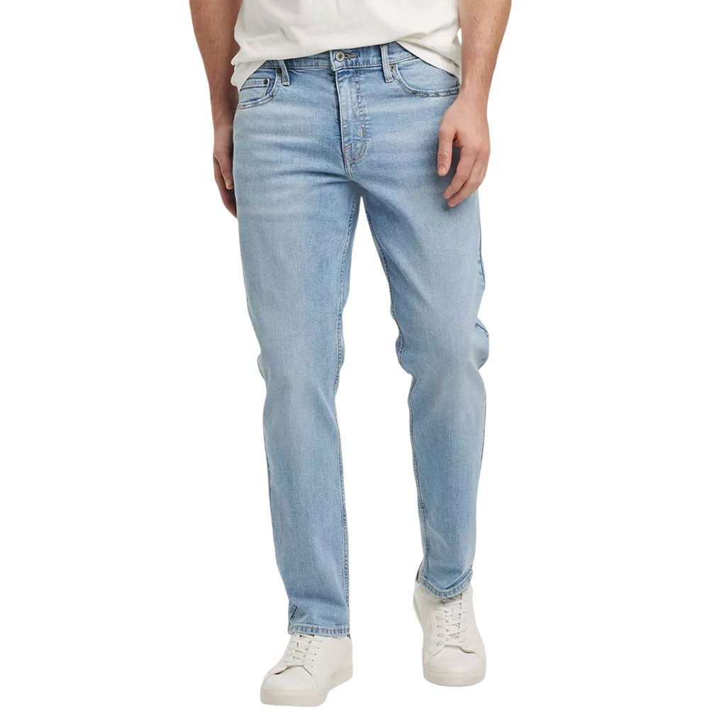 Light blue men's athletic fit jeans with button fly on white background