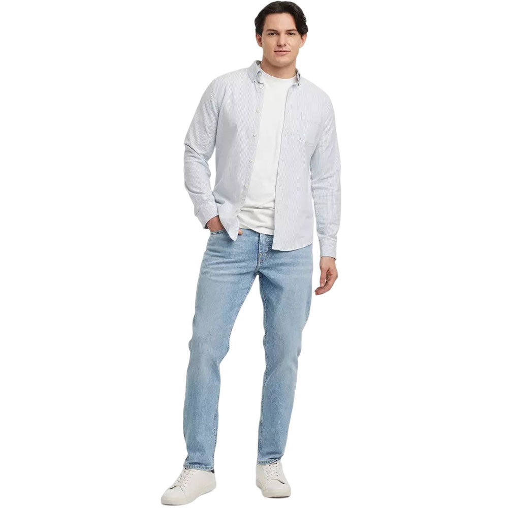 Light blue men's athletic fit jeans with button fly on white background