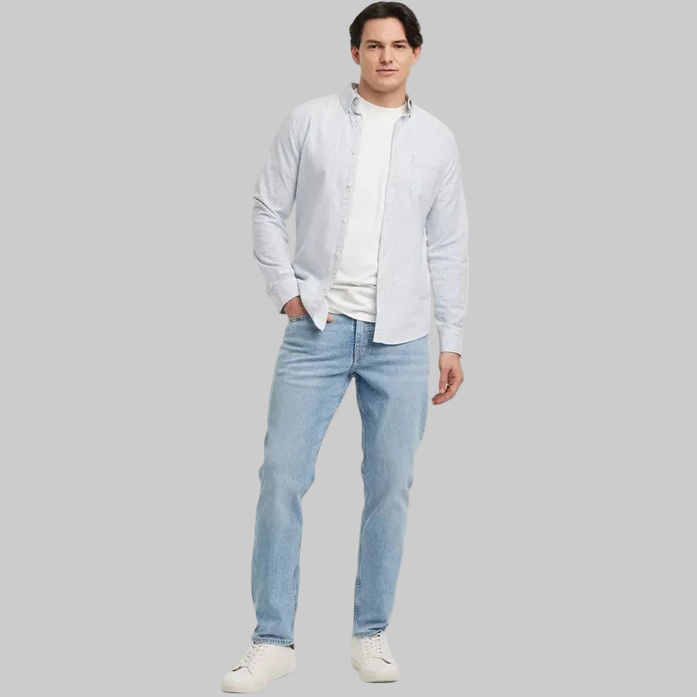 Light blue men's athletic fit jeans with button fly on white background