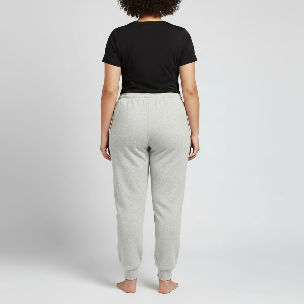 Light heather grey jersey jogger pants with a relaxed fit, elastic waistband, adjustable drawstring, and ribbed ankle cuffs, shown in a clean studio view for everyday comfort and casual wear.