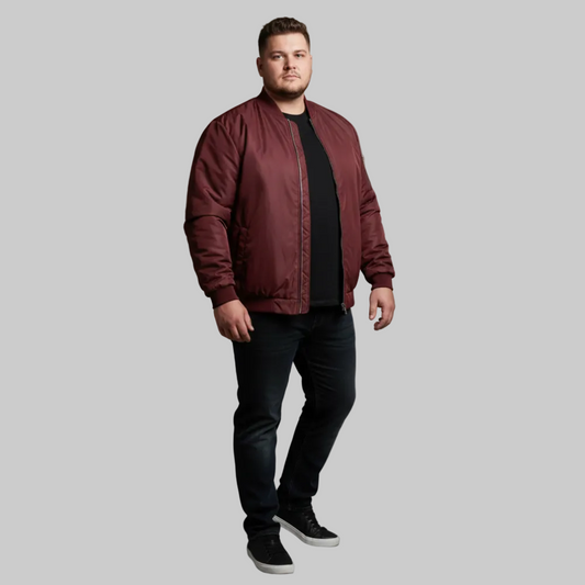 Maroon plus size bomber jacket with front zip closure and ribbed cuffs on a plain background.