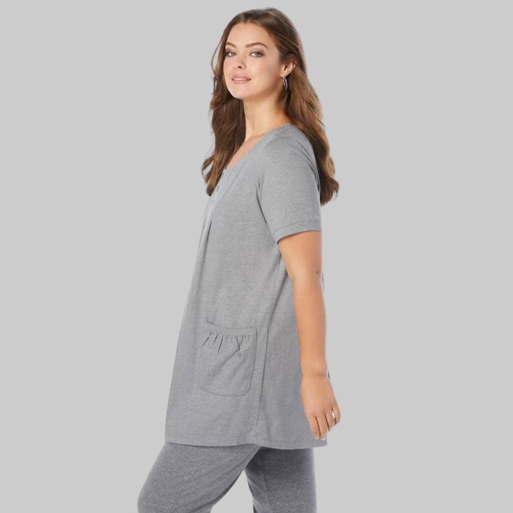 Plus-size woman wearing a medium heather grey two-pocket soft knit tunic with swing silhouette on a neutral studio background.