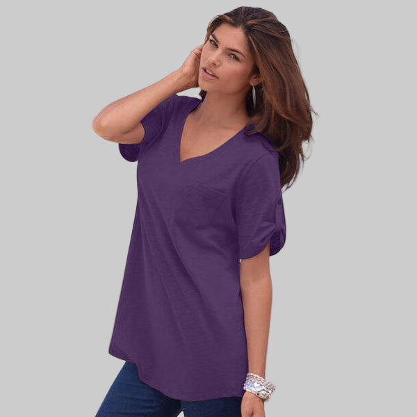 Women’s midnight violet V-neck cotton slub tunic with roll-tab sleeves, chest pocket, and high-low hem on a white background.