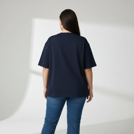 Person wearing a navy blue t-shirt and blue jeans on a white background