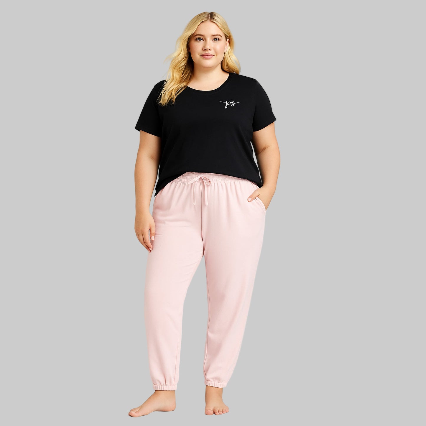 Plus-size woman wearing Misty Rose fleece jogger sweatpants with drawstring waist and elastic cuffs, styled with side pockets.