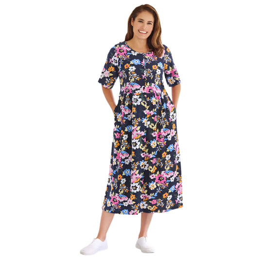 Woman wearing navy floral button-front dress with gathered waist and elbow sleeves