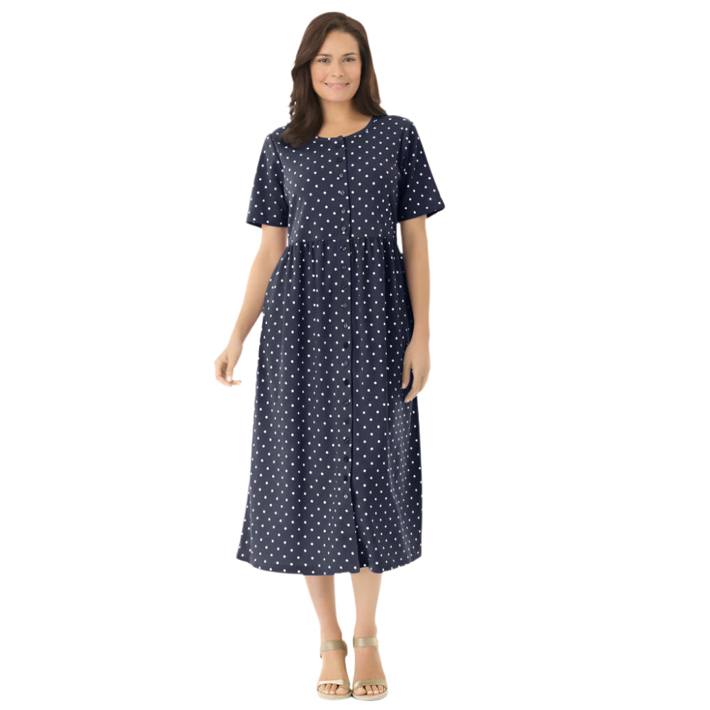 Woman wearing navy polka dot button-front dress with gathered waist and elbow sleeves