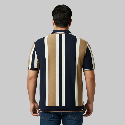Navy blue and camel vertical stripe polo shirt worn by a male model, featuring a classic collar and short sleeves on a studio background