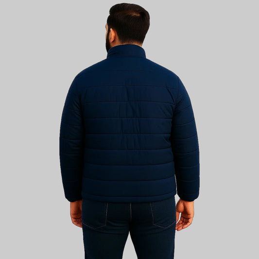 Man wearing a navy blue puffer jacket on a white background