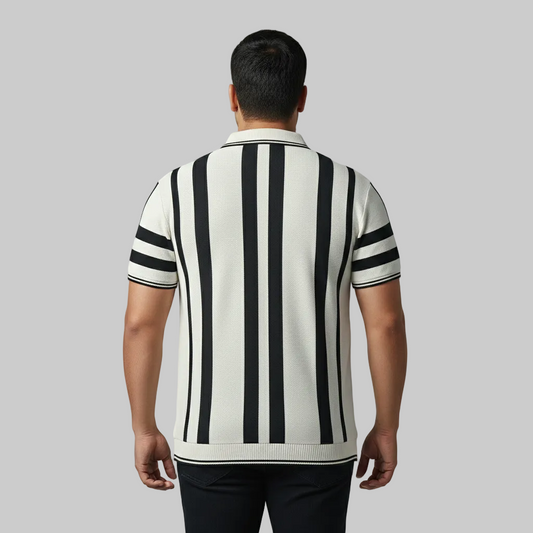 Off-white and black vertical stripe polo shirt worn by a male model, featuring short sleeves and a classic collar on a neutral studio background