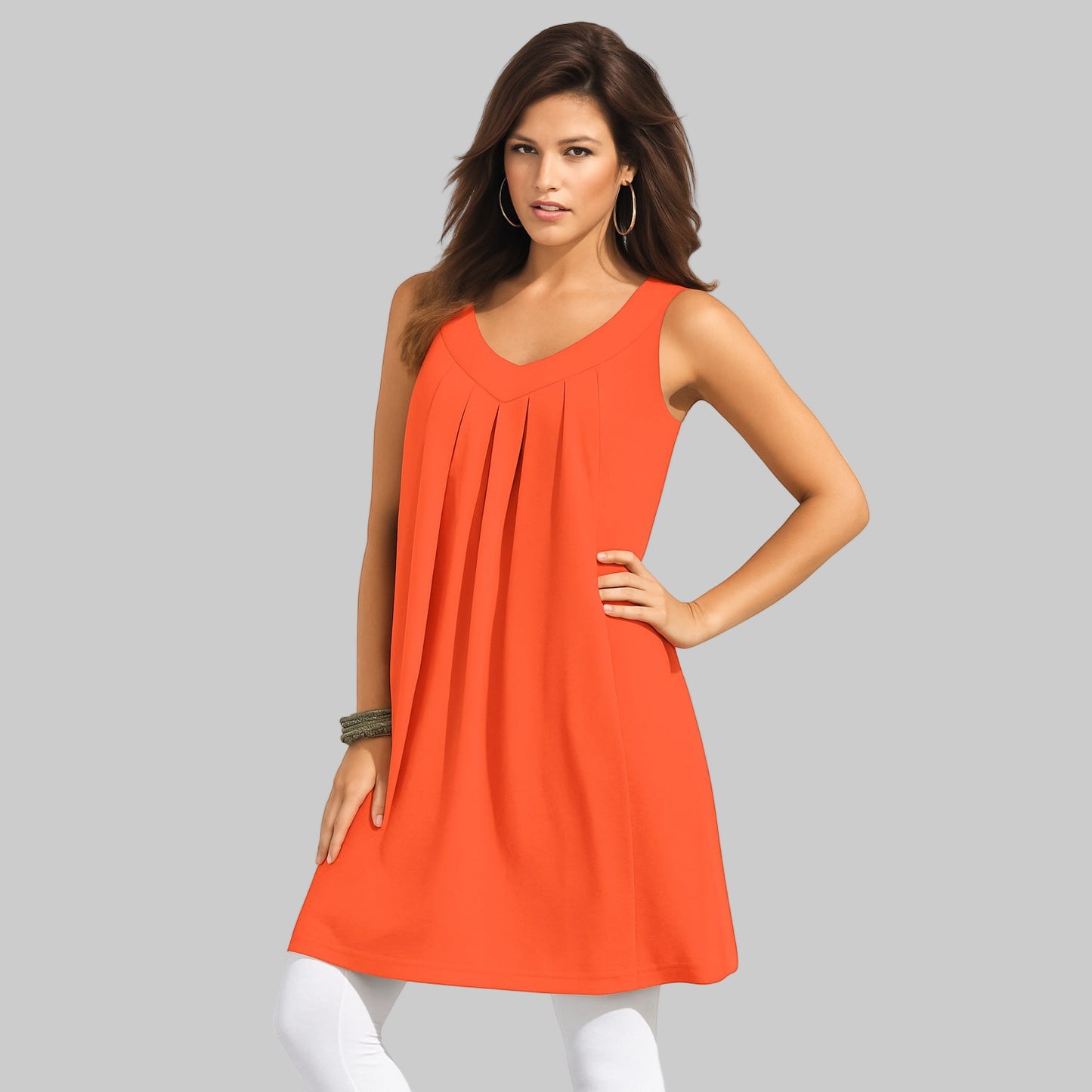Plus-size woman wearing an orange pleated sleeveless tunic tank with V-back design on a white background.