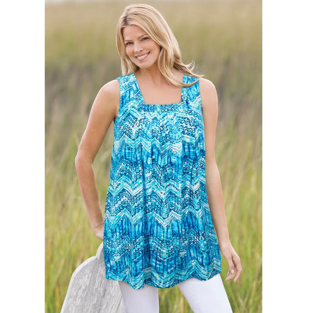 Woman wearing Paradise Blue swing tunic with square neckline, front pleats, and side pockets