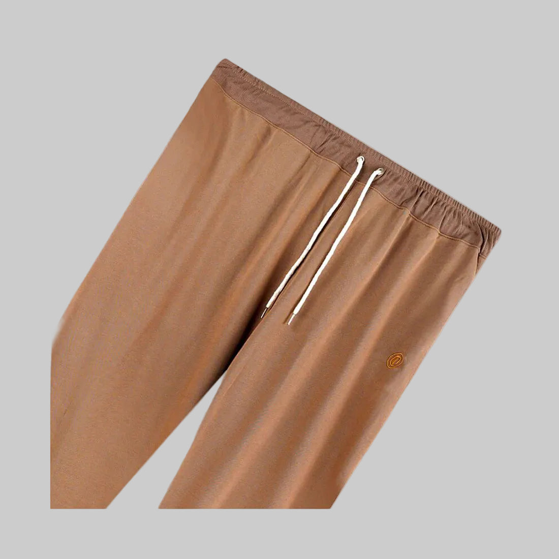 Peach brown plus-size terry joggers with a relaxed fit, soft loop-back fabric, elastic waistband, adjustable drawstring, and tapered legs, styled for everyday comfort and casual wear.