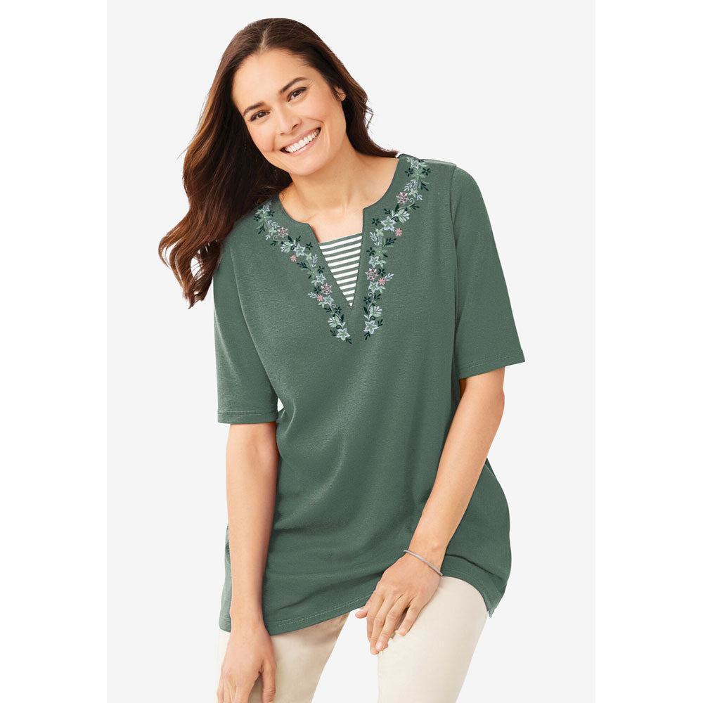 Plus-size 2-in-1 tunic with a notch neckline, striped contrast inset, and embroidered detail. Relaxed fit with elbow-length sleeves and a 30” tunic length.
