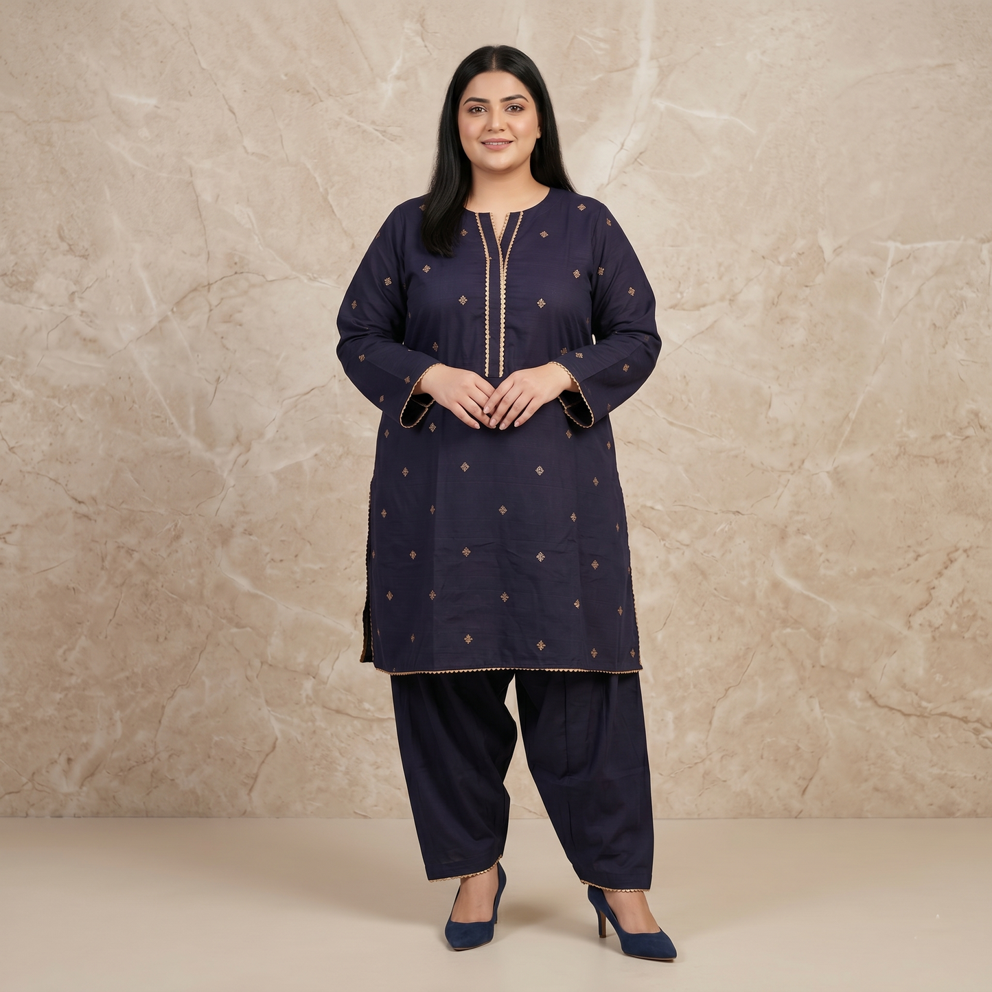 Woman wearing a navy blue traditional outfit with gold embroidery against a beige background