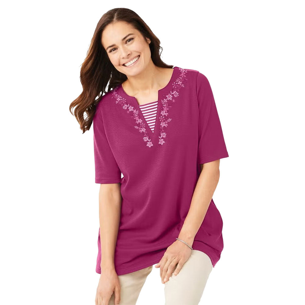 Plus-size 2-in-1 tunic with a notch neckline, striped contrast inset, and embroidered detail. Relaxed fit with elbow-length sleeves and a 30” tunic length.