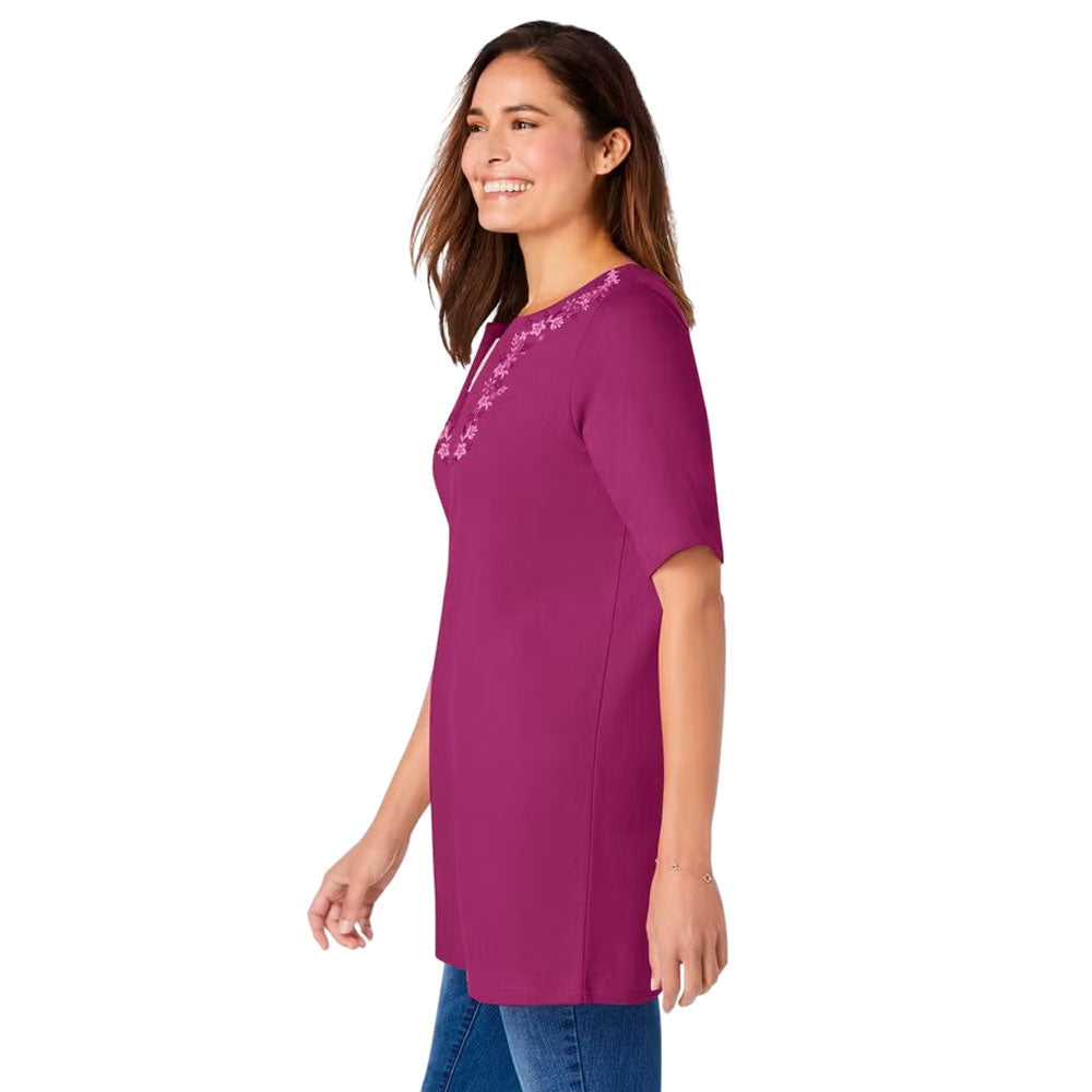 Plus-size 2-in-1 tunic with a notch neckline, striped contrast inset, and embroidered detail. Relaxed fit with elbow-length sleeves and a 30” tunic length.