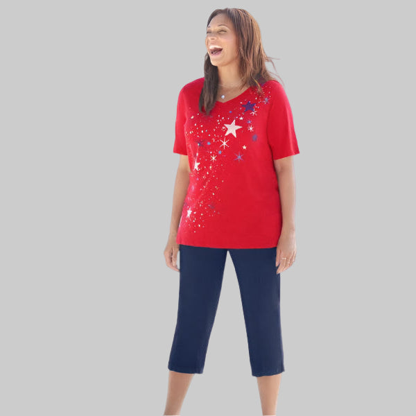 Plus size woman wearing red V-neck tee with falling stars graphic and silvertone shine