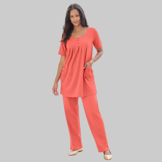 Sunset Coral Two Pocket Soft Knit Tunic with a scoop neckline, short sleeves, and functional pockets. Available in plus sizes 1X to 5X for a comfortable fit.