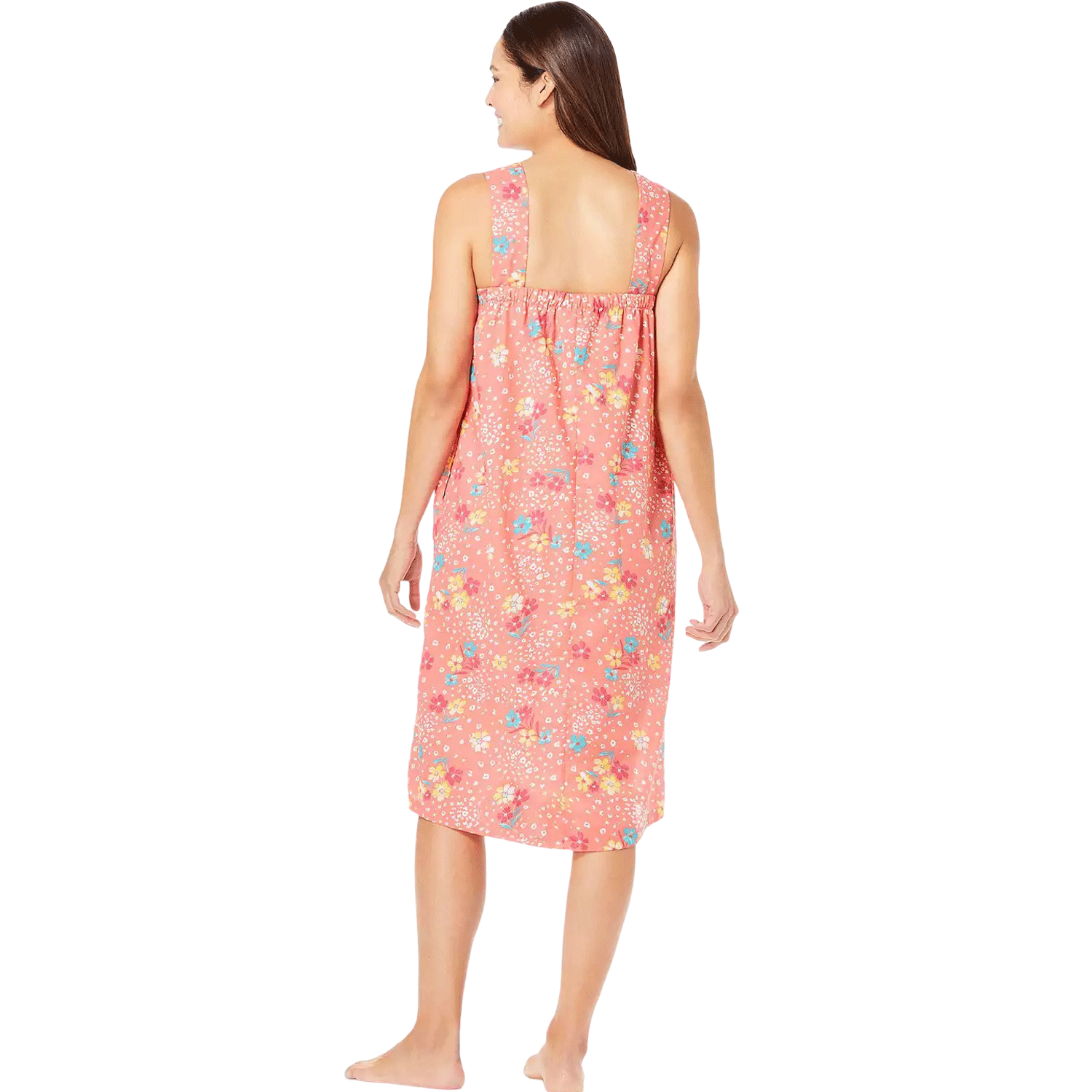 Plus-size woman wearing a sleeveless, mid-length lounger with a sweet coral floral print, featuring a square neckline, shirred yoke, and side pockets.