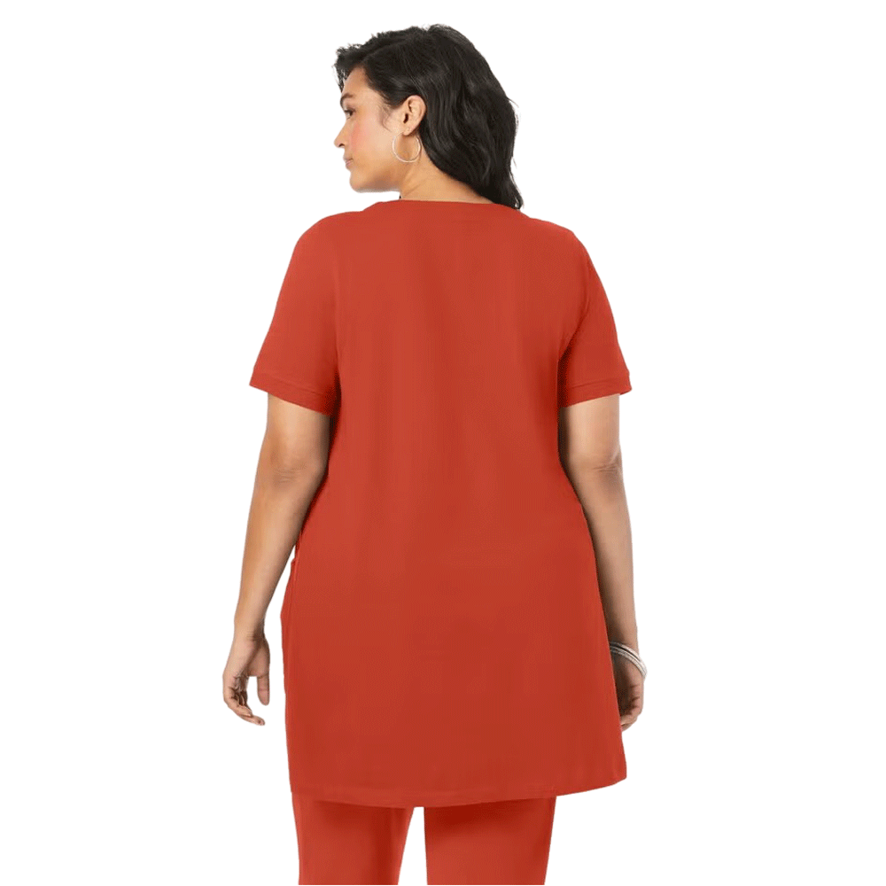 A woman wearing a Rust Orange Two Pocket Soft Knit Tunic with short sleeves, a scoop neckline, and two front pockets, styled with jeans for a casual look.