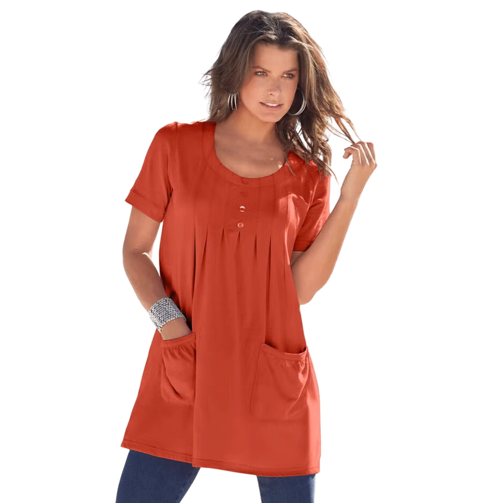 A woman wearing a Rust Orange Two Pocket Soft Knit Tunic with short sleeves, a scoop neckline, and two front pockets, styled with jeans for a casual look.