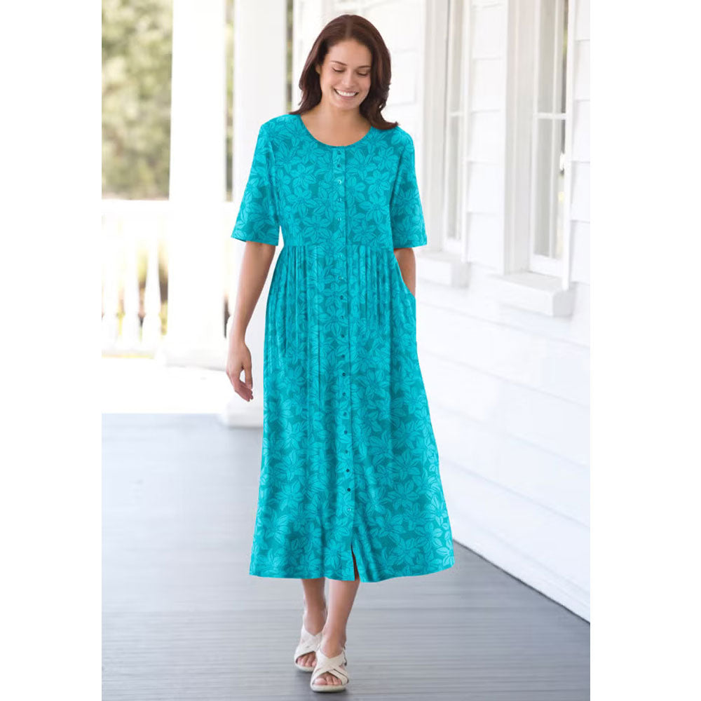 Woman wearing soft blue floral button-front dress with elbow sleeves and flowing skirt