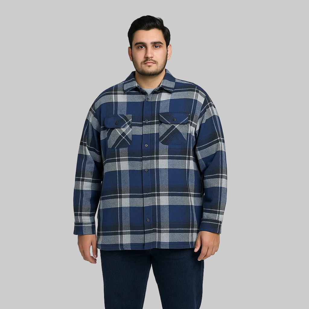 Navy plaid fleece-lined flannel shirt jacket for men with button front, chest pockets, and side pockets, displayed on a plain background.