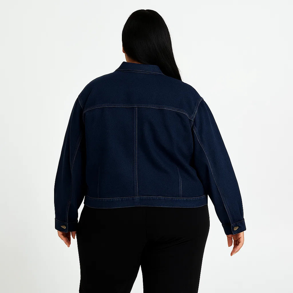Plus-size woman wearing dark wash denim jacket with button front and flap chest pockets