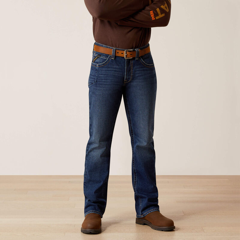 Plus-size male model wearing Galveston Relaxed Boot Cut Jeans in dark denim, showing relaxed fit, classic boot-cut leg opening, and durable workwear details.